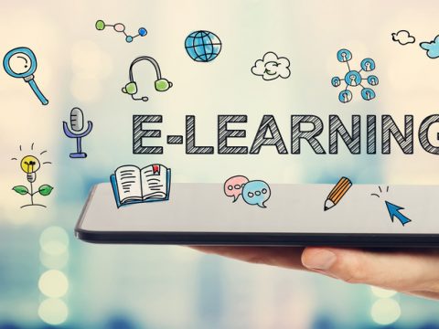 E-learning concept with man holding a tablet